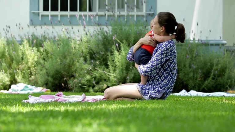 A parent standing outside taking a deep, calming breath to relieve air hunger and stress.