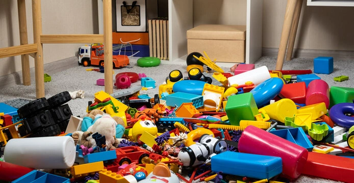 A floor scattered with colorful toys, representing the sensory overload that can cause parental anxiety.