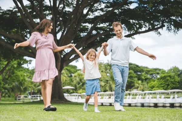 A happy parent and child embracing outdoors, highlighting the importance of real-life connection over social media perfection.