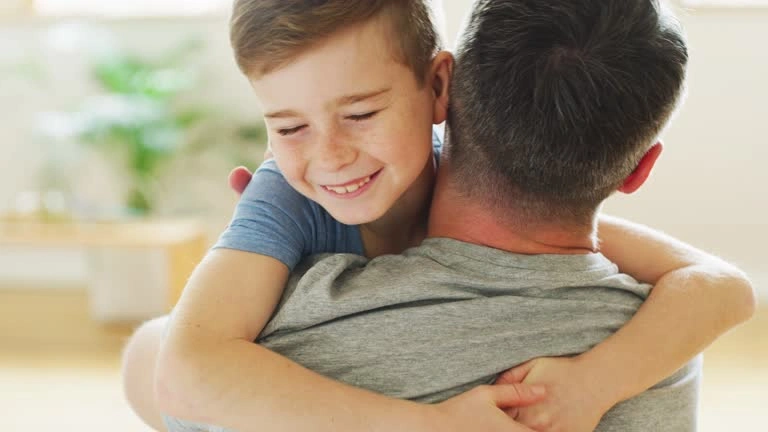 A parent gently hugging their toddler, representing the importance of love and security in child development.