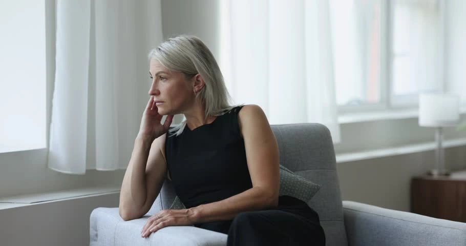 A pensive-looking parent sitting alone