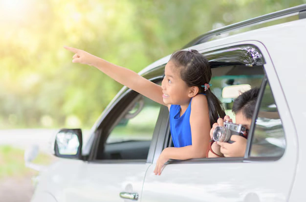 A teenager looking out the car window while a parent drives, illustrating side-by-side bonding.