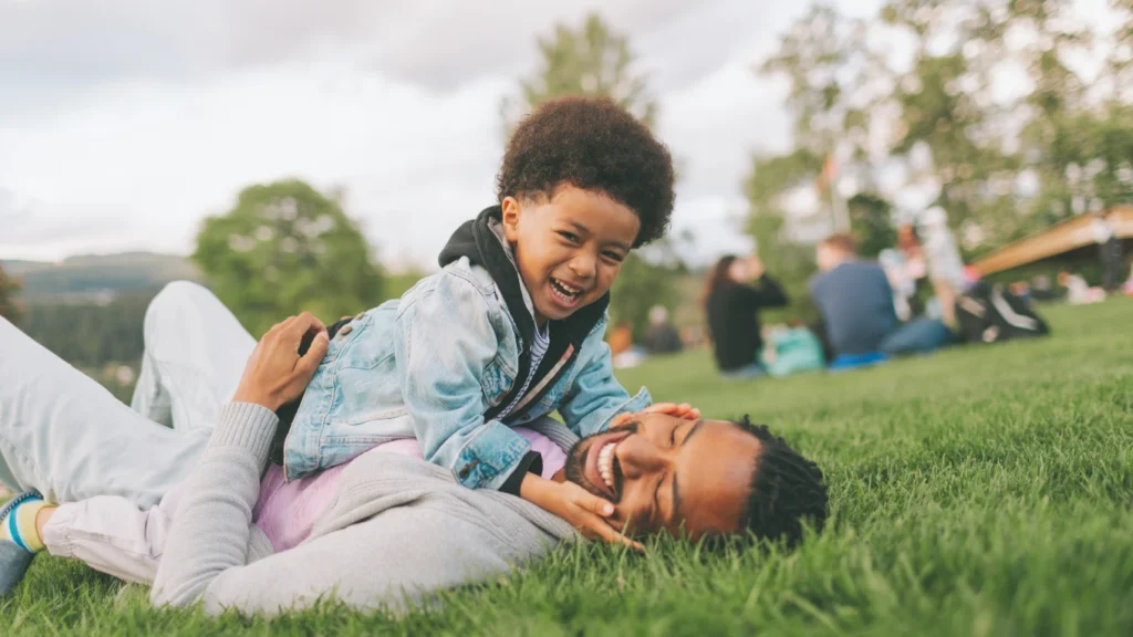 A happy parent connecting with their child, representing the positive results of protecting mental health through boundaries