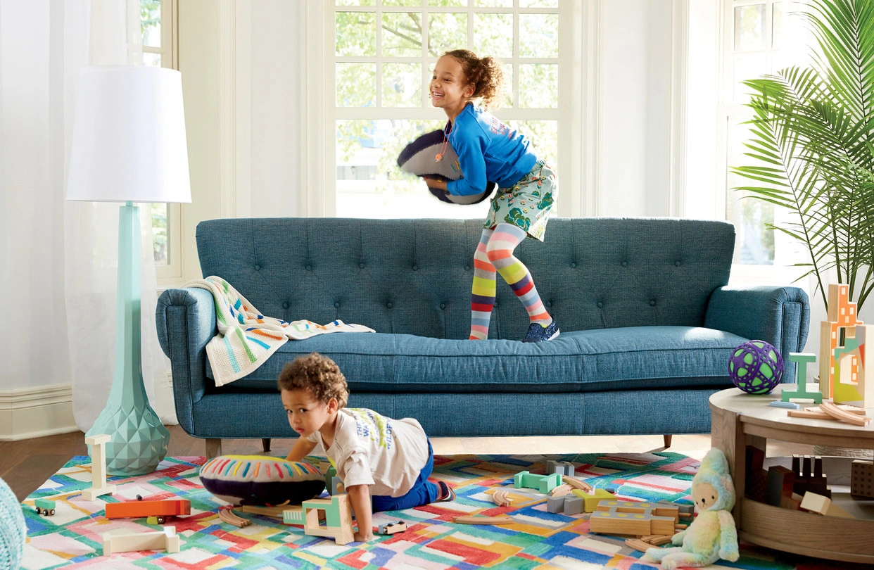 A living room setting showing a mix of modern toys and traditional cultural decor, representing a bicultural home environment.