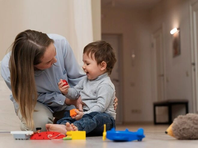 A toddler engaging in a serve-and-return interaction with a parent, demonstrating Bronfenbrenner's microsystem theory.