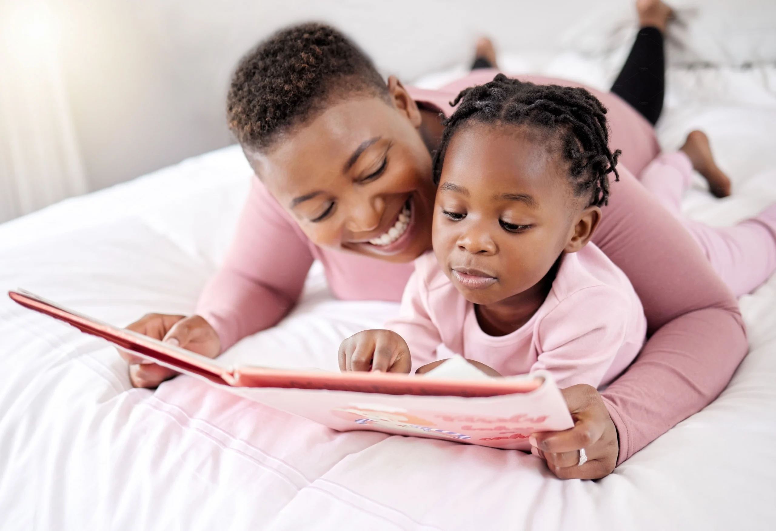 Parent and child reading together at bedtime as part of a nightly family ritual.