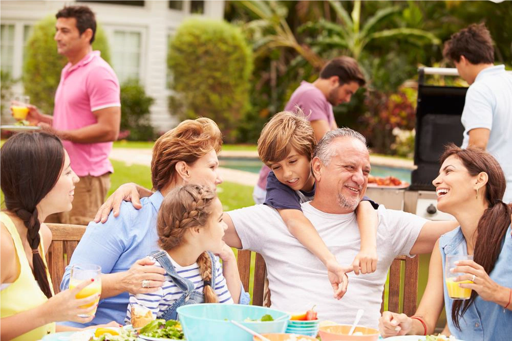 Multi-generational family sharing a meal together, illustrating the role of family rituals in building identity