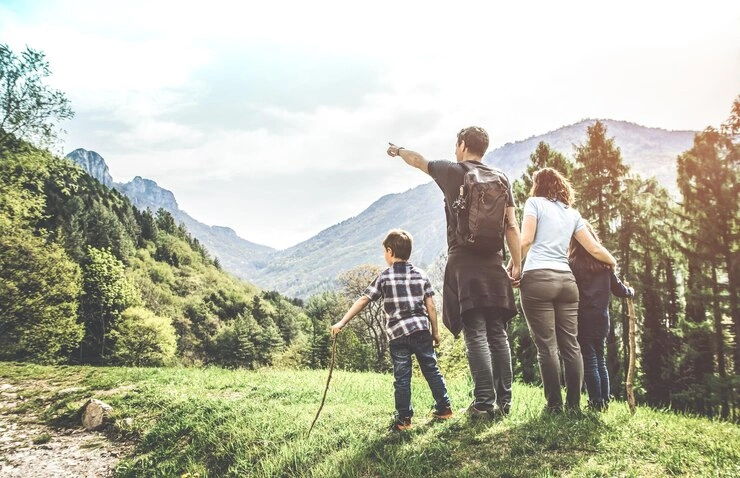 Family enjoying their yearly hiking tradition together on a nature trail